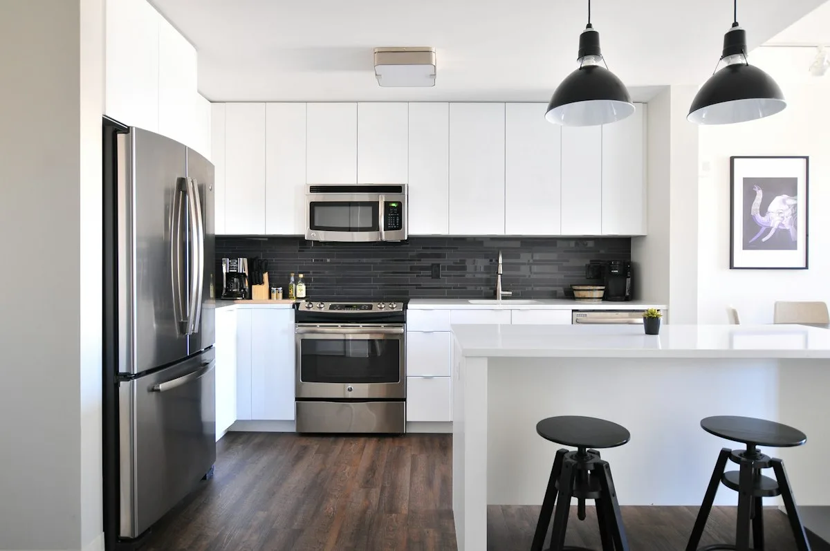A bright apartment kitchen with a breakfast counter