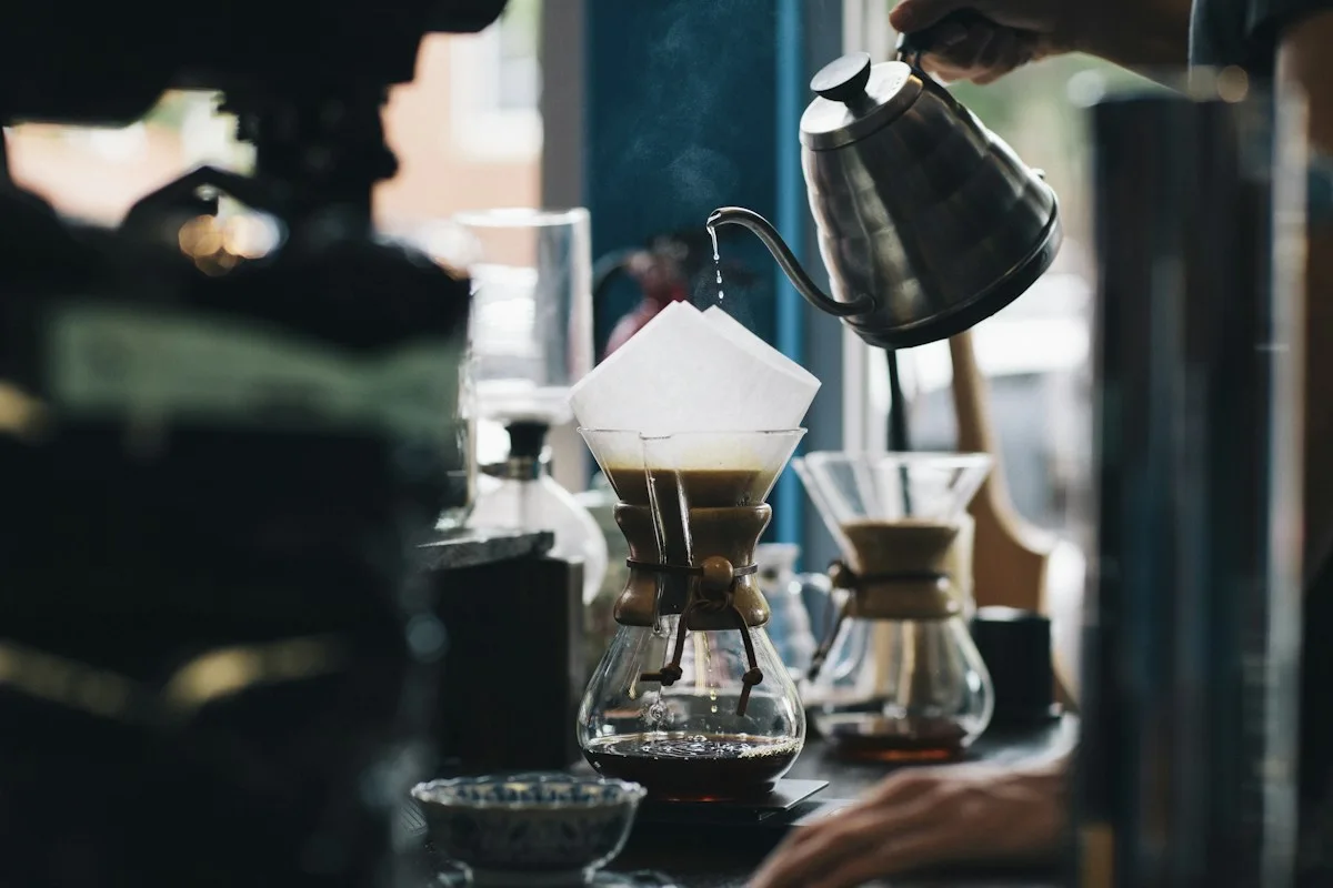 Coffee equipment and a black kettle on a counter