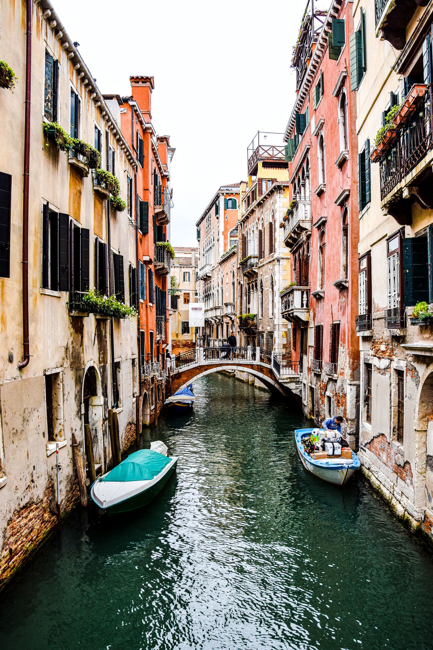 Historic buildings and an arched bridge beside a canal in Venice, Italy